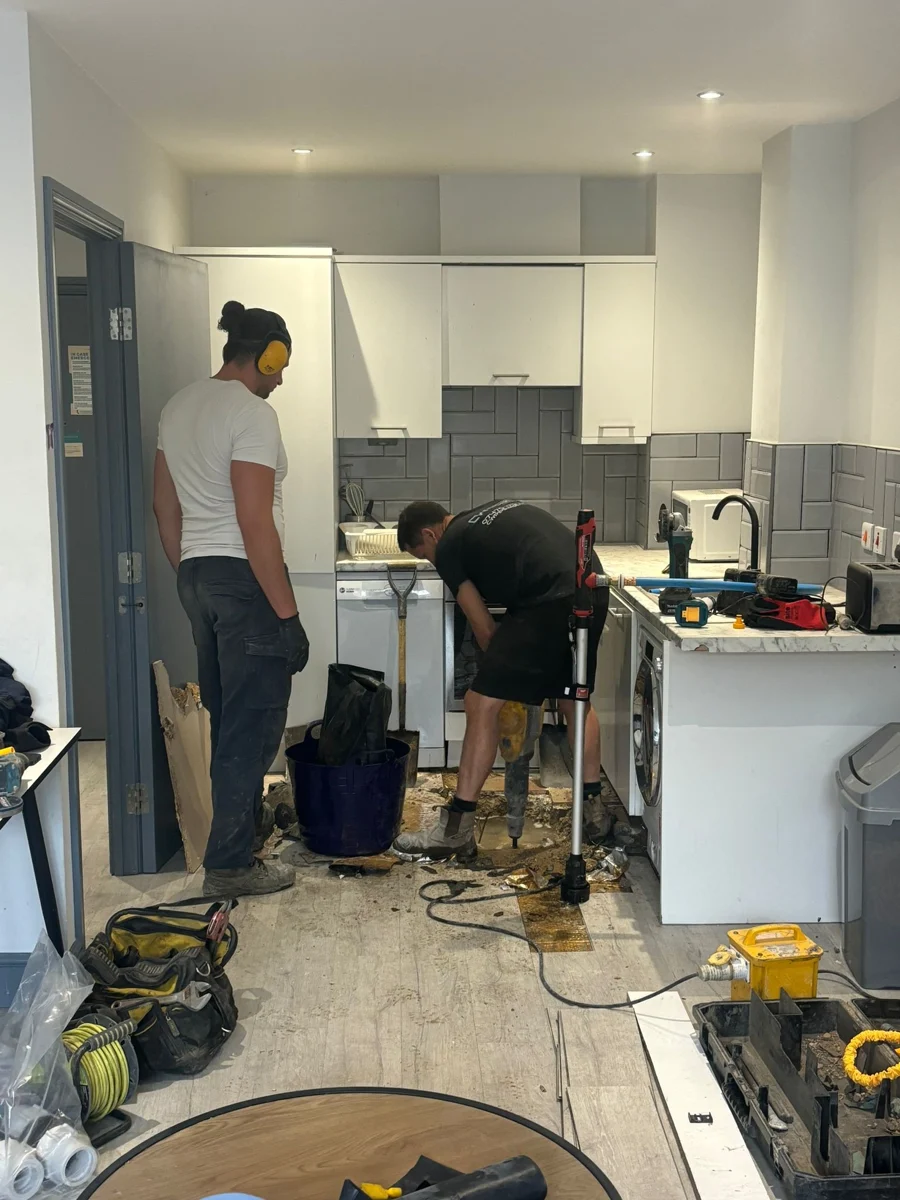 CW Pipewise team and equipment in a kitchen work area