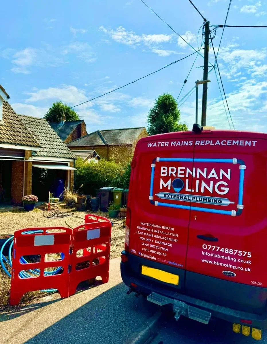 Brennan’s vehicle and barriers beside a residential work area.