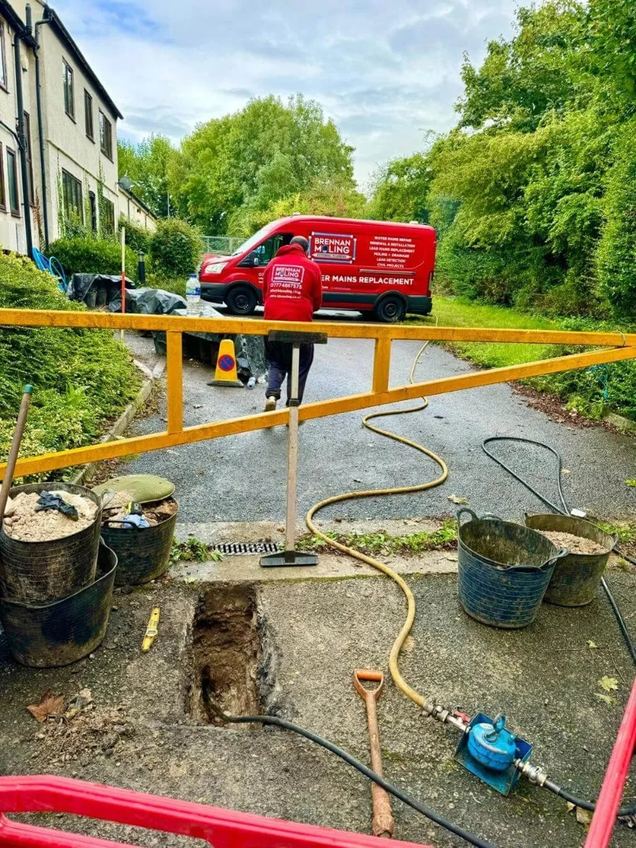 Brennan’s equipment and barriers around a pavement excavation.