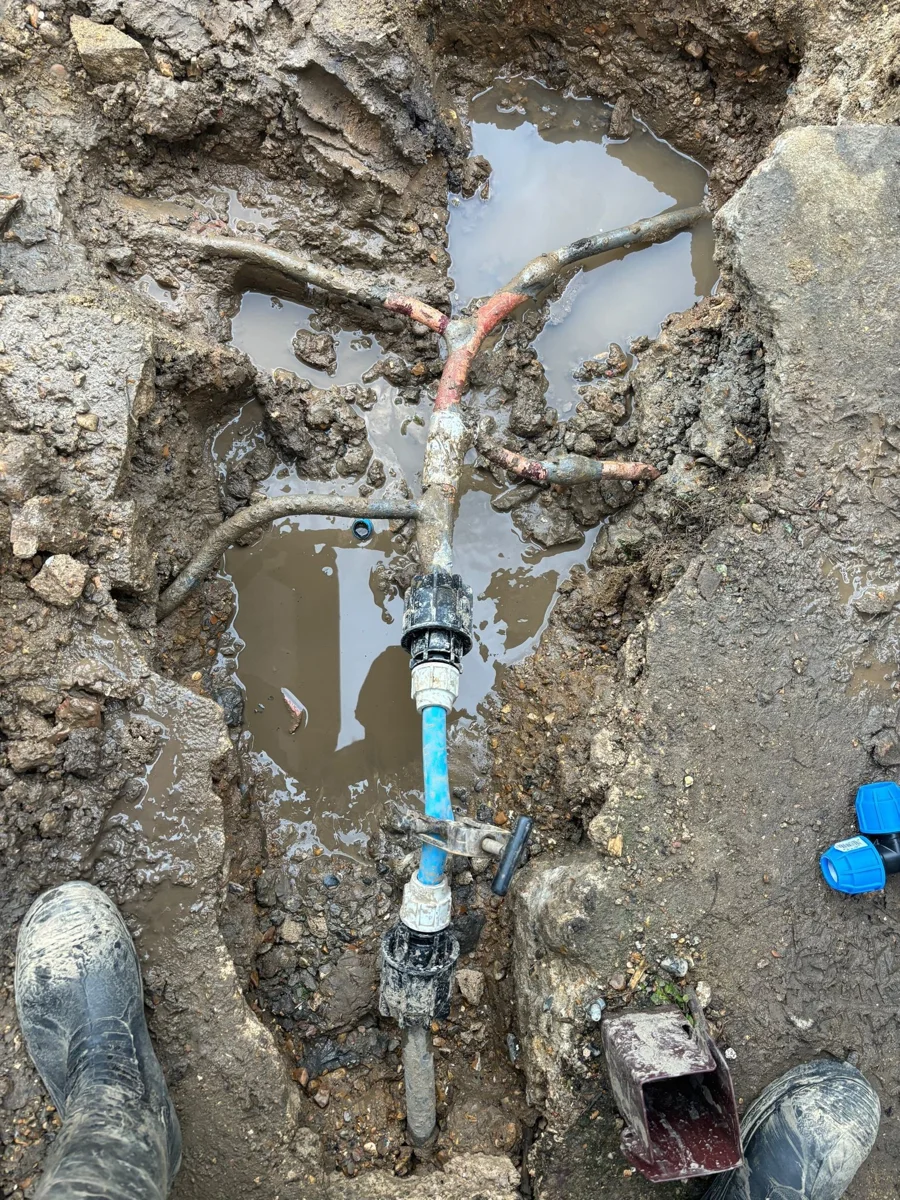 New pipe connections photographed within an opened work area.