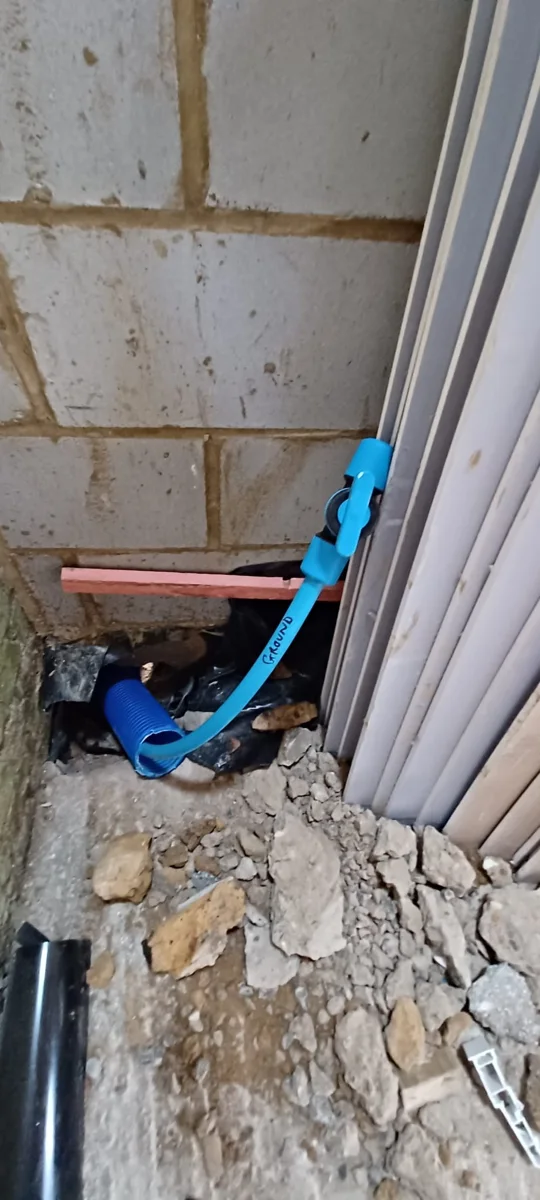 Blue pipework approaching the internal connection point.