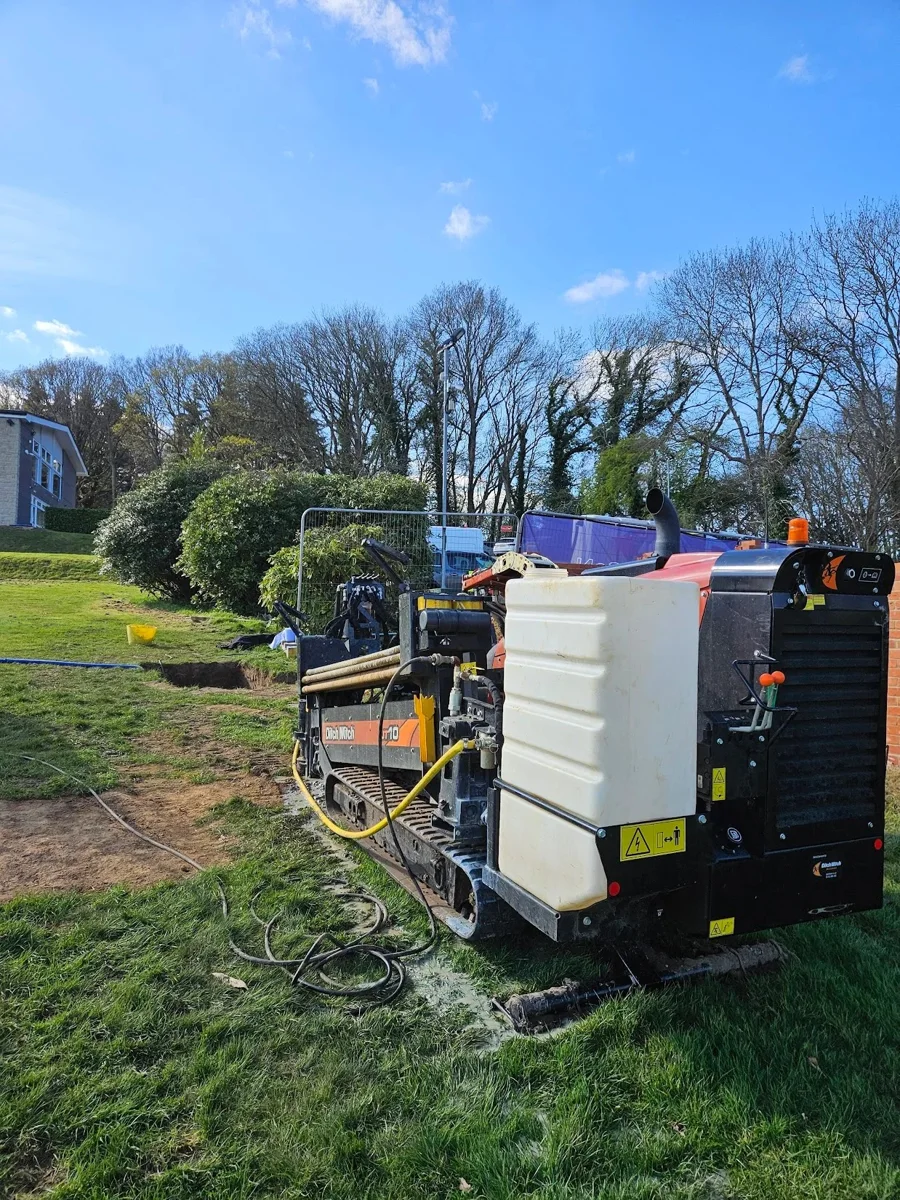 A fluid tank and equipment beside a directional drilling work area.
