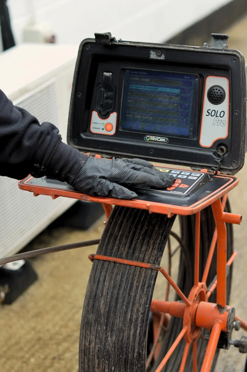 An inspection camera monitor and cable reel prepared for use.
