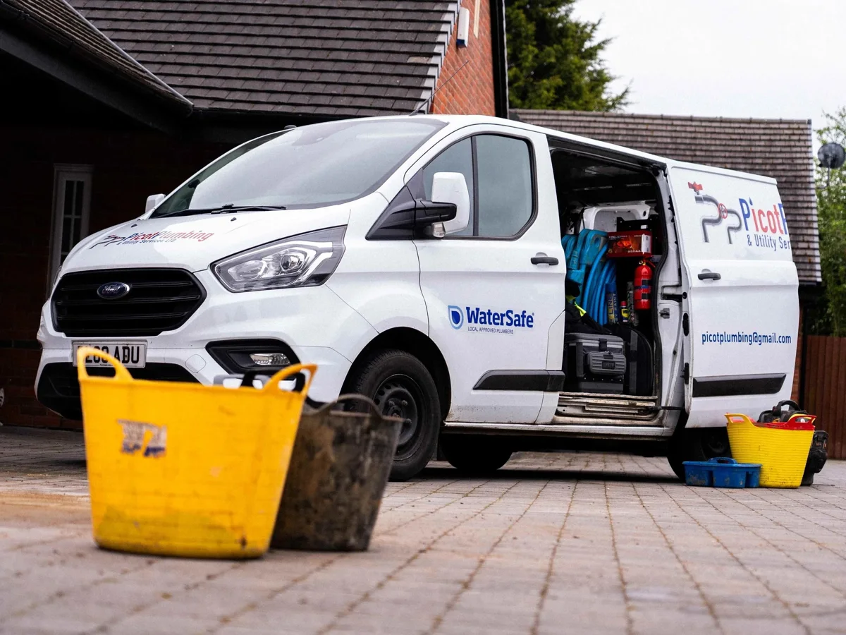Picot’s service van beside tools and materials at a property.