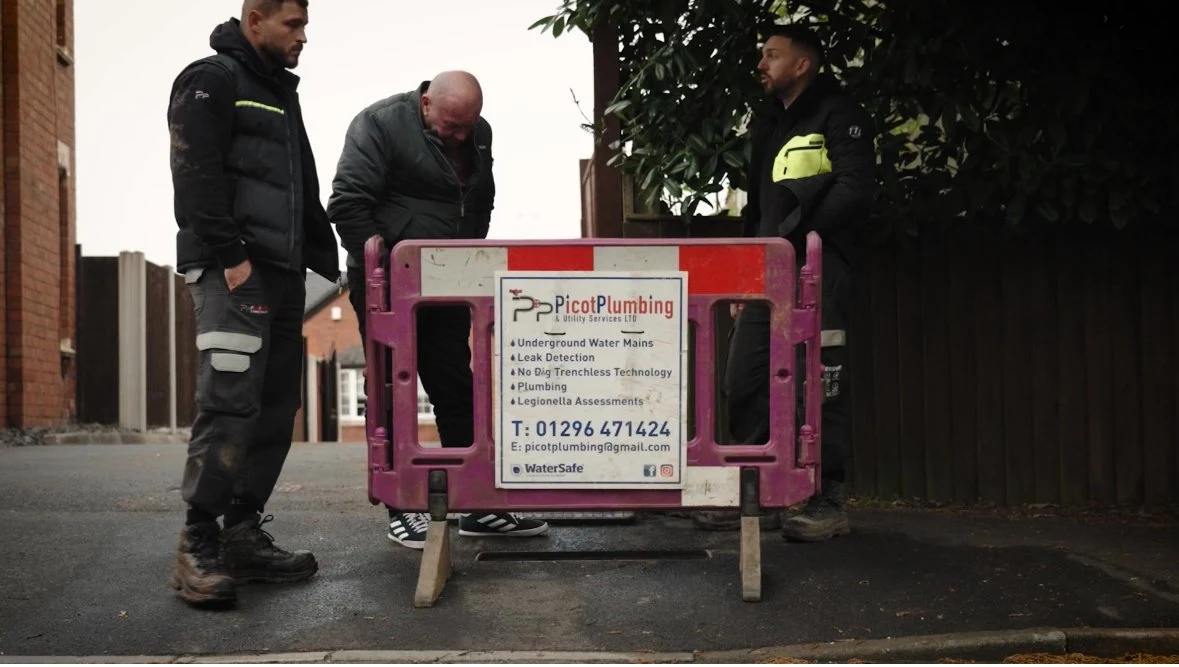 Picot engineers beside a work barrier